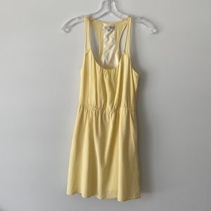 A pale yellow, racer back 100% silk, preowned , good condition dress